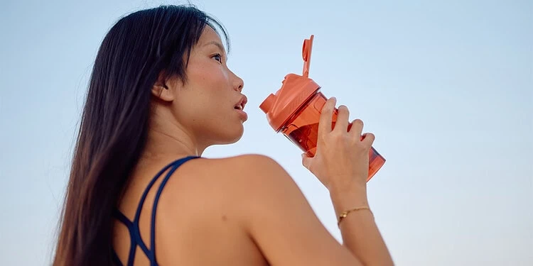 Athlete drinking from a shaker bottle